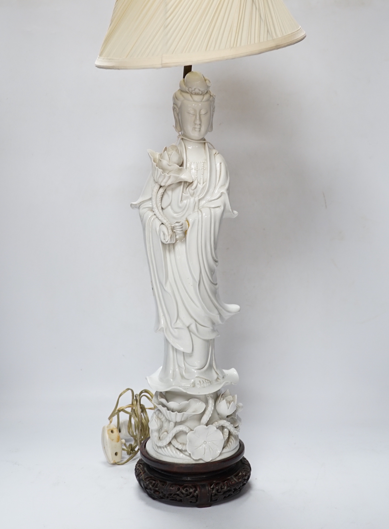 A Chinese blanc de chine figure of Guanyin, 71cm with shade